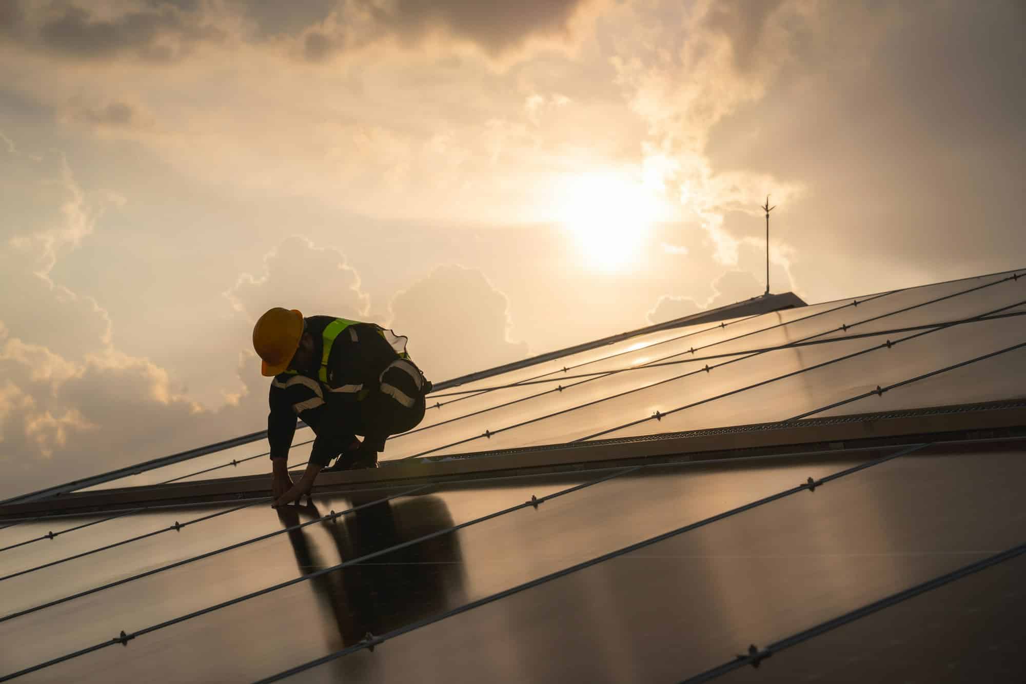 Techniques checking solar cell on the roof for maintenance. Clean energy concept.